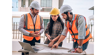 Contractors reviewing plans at a construction site