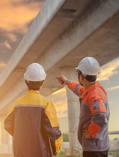 Engineers inspecting an infrastructure project at sunset